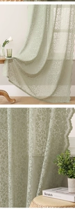 Detail of light green lace curtain with floral embroidery and elegant scalloped edges