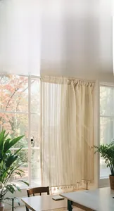 Close-up of linen blend curtain showing intricate woven texture and decorative tassels