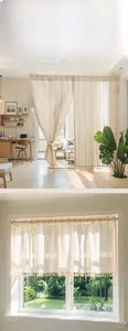 Detail showing cream linen curtain with vertical stripes and delicate tassel fringe