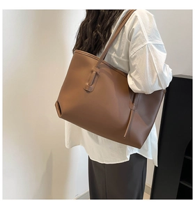 Brown tote bag shown on shoulder model, large capacity leather bag for office commute