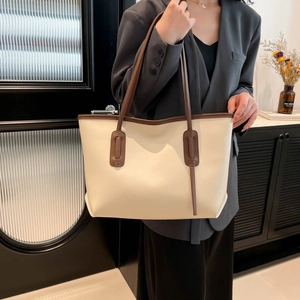 Minimalist cream tote bag with brown handles and large capacity for daily commute