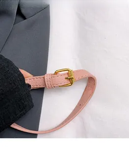 Detailed close-up of pink litchi grain leather strap with premium gold pin buckle hardware
