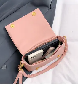 Macro view of pink lychee leather handbag showing spacious interior and storage