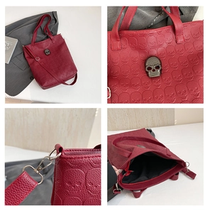 Macro view of burgundy embossed skull tote bag with silver hardware and vintage detail