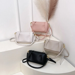Pleated cloud bag in soft leather with top handle, shown in four elegant colors