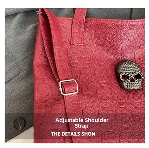Detail of red punk tote featuring skull embossed texture and adjustable shoulder strap