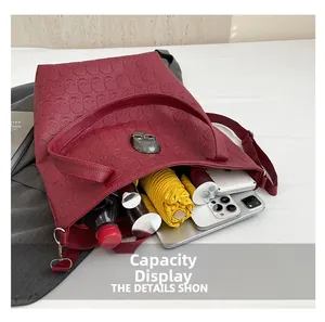 Deep red skull embossed tote bag showing spacious interior with daily essentials