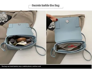 Detail view of light blue leather handbag interior with spacious main compartment