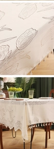 Close-up of cream tulip jacquard tablecloth featuring elegant white tassel edge details
