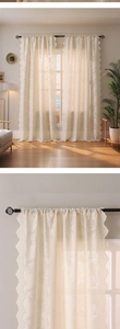 Detail of French tulip embroidery on cream lace curtain with scalloped edges