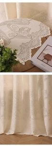 Detail of tulip lace curtain fabric with intricate embroidery and elegant scalloped edges