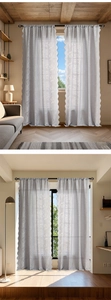 Detail of white tulip embroidered lace curtains with elegant scalloped edges and floral patterns