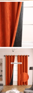 Detail of orange embossed floral blackout curtain with grommets and black lining