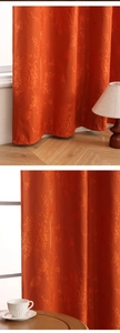 Detail of orange floral jacquard blackout curtain with fine stitching and fabric texture
