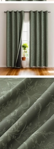 Macro detail of sage green blackout curtain with leaf embossed jacquard fabric textures