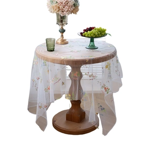 White mesh tablecloth with floral butterfly embroidery and scalloped edges for round tables
