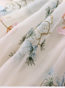 Close-up of pine tree embroidery on white sheer mesh fabric for Chinese style tablecloth