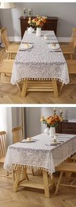 Detailed macro of cream floral lace tablecloth with elegant tassel fringe edge
