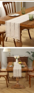Close-up of bohemian ivory woven table runner with intricate hollow crochet and tassels