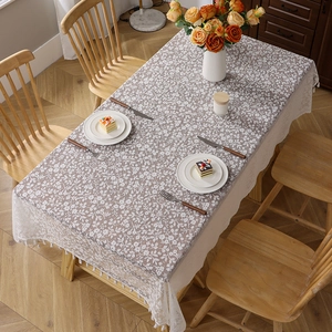 French style floral lace tablecloth with fringe trim on a cozy wooden dining table