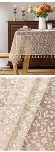 Macro detail of French floral jacquard lace tablecloth with elegant tassel edges