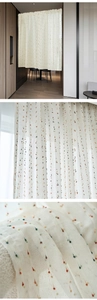 Detail of sheer beige curtain with colorful pompoms and textured linen-like fabric weave