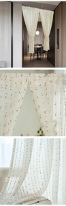 Detail of sheer cafe curtain with colorful embroidered dots on cream semi-transparent fabric