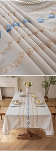 Close-up of bohemian embroidered tablecloth with geometric patterns and fringe tassels