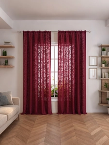 Detailed texture of burgundy lace curtain with vintage floral embroidery and rod pocket
