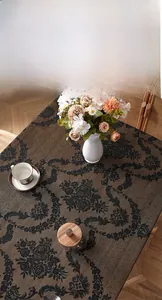 Close-up of retro dark coffee lace tablecloth with damask floral texture and fine weave
