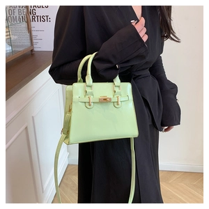 Detail of mint green PU leather bag with gold twist-lock and detachable shoulder strap