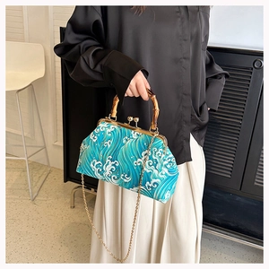 Detail of wave pattern jacquard fabric on crossbody bag with bamboo handle