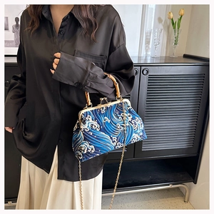 Detail of bamboo handle and blue wave fabric on a vintage Chinese style handbag