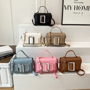 Retro drawstring handbag with large square buckle in multiple colors on display