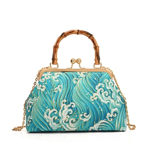 Retro Chinese style blue wave pattern handbag with bamboo handle and metal chain