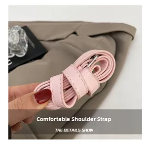 Detail of light pink PU leather strap with fine stitching and adjustable silver buckle