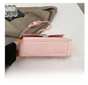 Close-up of the durable reinforced base on a pink PU leather crossbody square bag