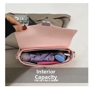 Detail showing high interior capacity of the pink crossbody bag for daily essentials