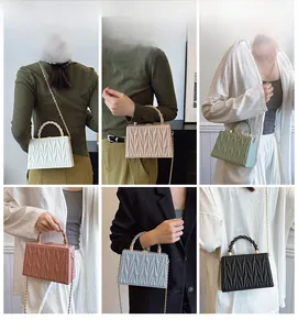Collage of quilted crossbody bags in six colors shown with twisted handles and gold chains