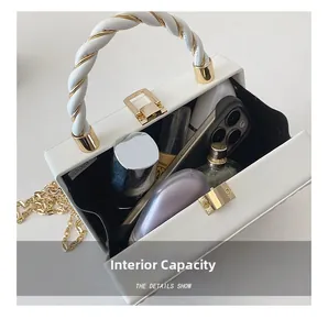 Internal capacity of the white hard shell handbag with woven handle and gold chain strap
