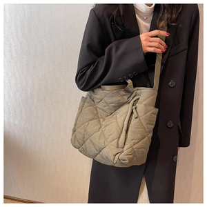 Detailed view of olive green quilted tote bag featuring a high-quality puffer texture