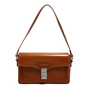 Minimalist caramel brown leather shoulder bag with silver metal buckle closure