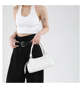 White Boston handbag details with metal eyelets and double top handles on model