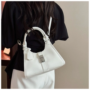 Rear view of model wearing white pleated dumpling bag with silver clasp and fine leather strap