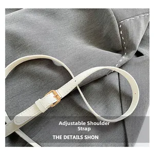 Close-up of white lychee leather adjustable strap with gold metal buckle and stitching