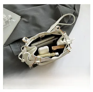 Interior view of white bucket bag showing large capacity for phone and cosmetics