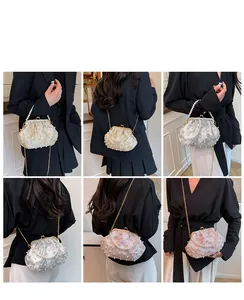 Three-color pearl evening bags with floral textures shown on model for size and style