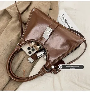 Detail view of the brown leather bag interior showing space for phone and lipstick
