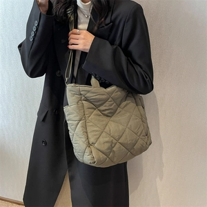 Olive green quilted tote bag with large diamond stitching and versatile shoulder straps