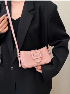 Detail of pink denim baguette bag with large square buckle on black oversized blazer